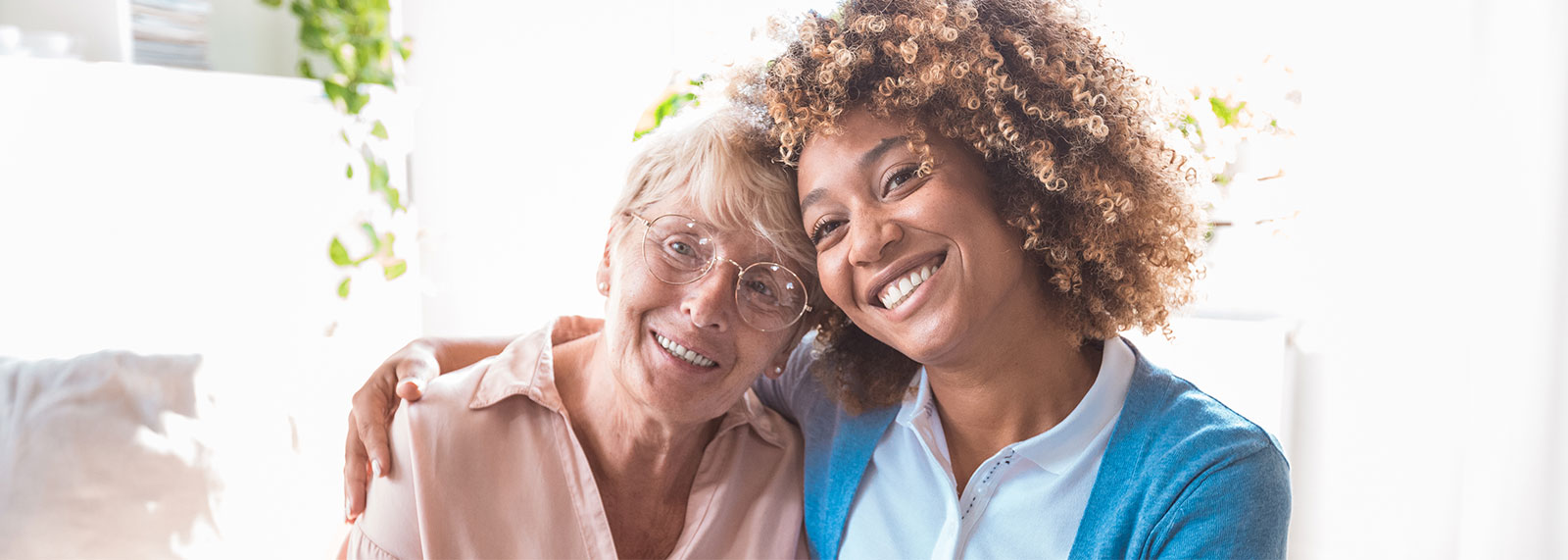 caregiver hugging a senior woman