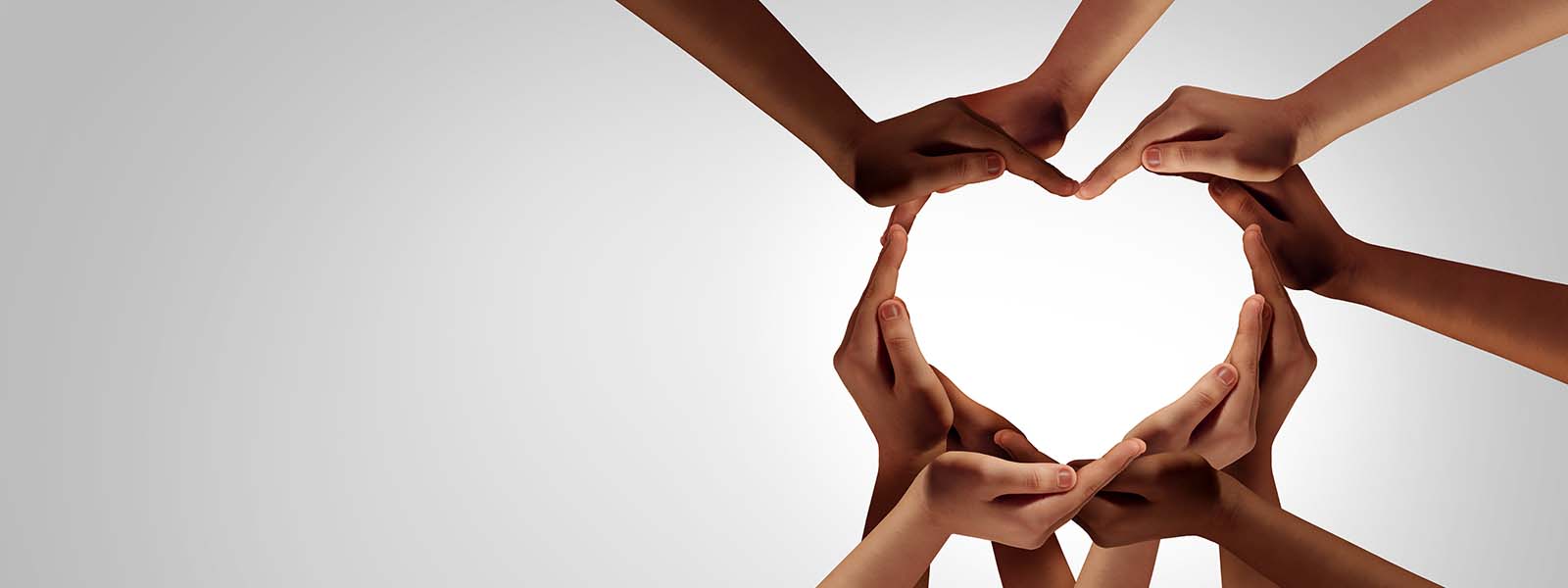 Unity and diversity partnership as heart hands in a group of diverse people